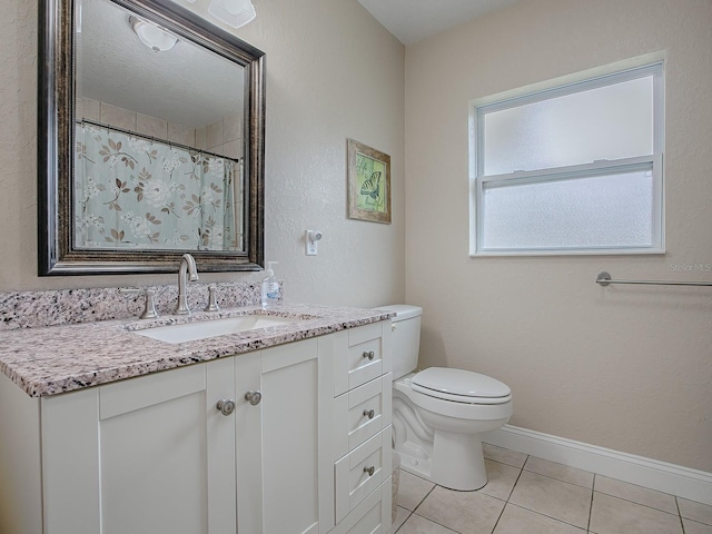 bathroom featuring tile patterned floors, toilet, and vanity