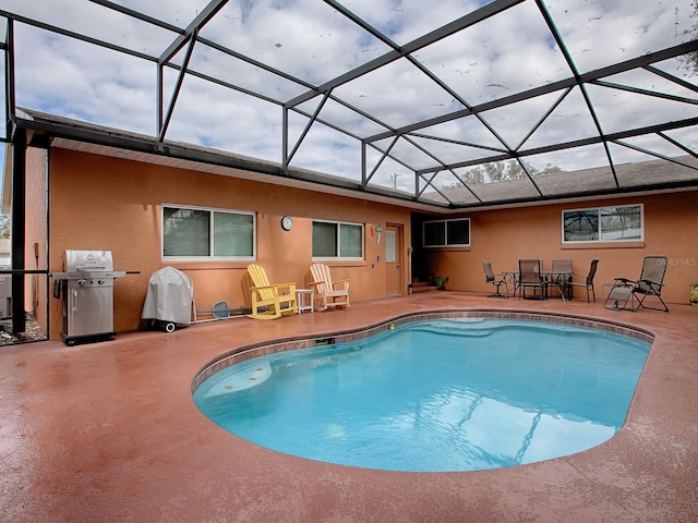 view of pool featuring a patio, a lanai, and grilling area