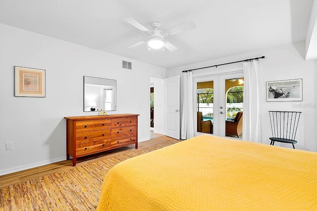 bedroom with hardwood / wood-style floors, access to outside, french doors, and ceiling fan