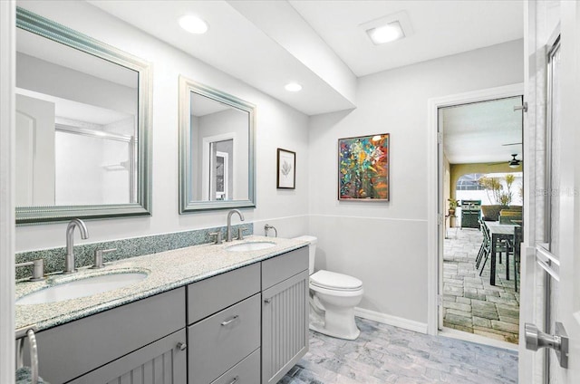 bathroom featuring ceiling fan, vanity, and toilet