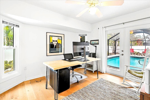 home office with light hardwood / wood-style flooring, french doors, and ceiling fan