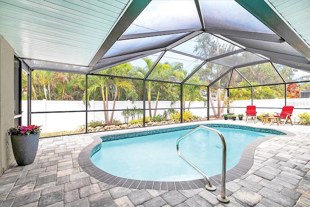 view of swimming pool featuring a lanai and a patio