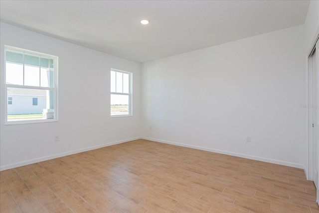 spare room with light hardwood / wood-style floors