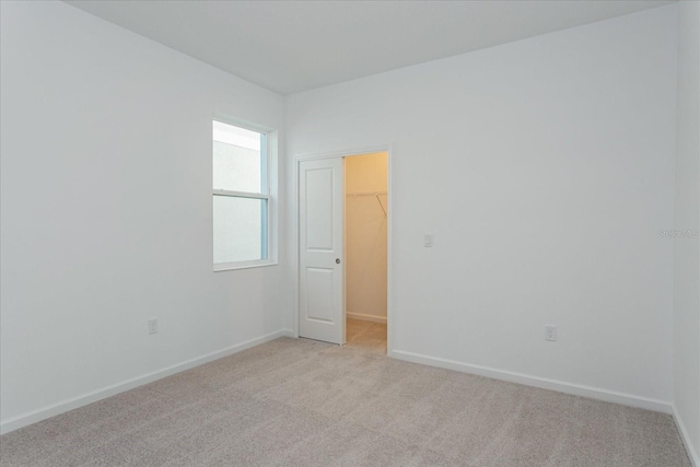 unfurnished room with light carpet