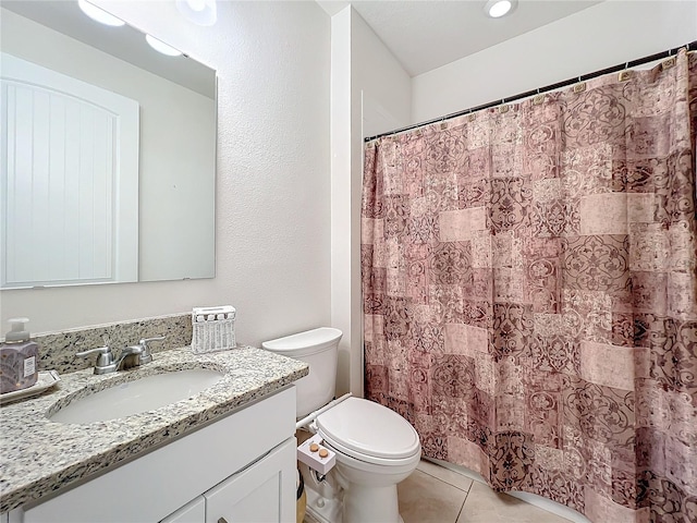 bathroom with vanity, tile patterned floors, and toilet