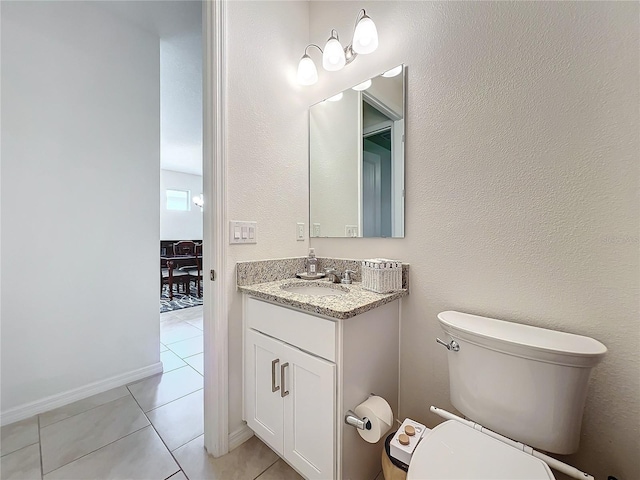 bathroom featuring vanity, toilet, and tile patterned flooring