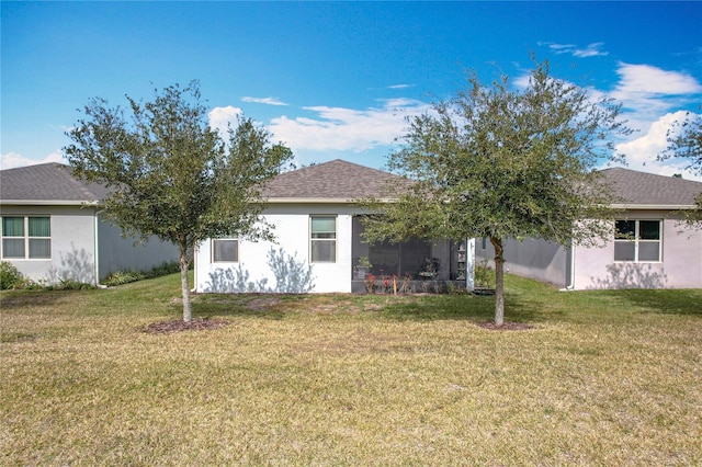 back of property featuring a lawn