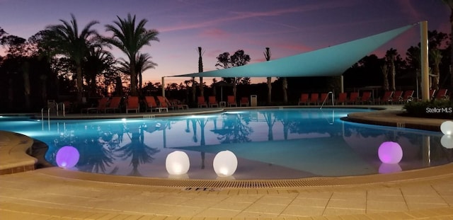 view of pool at dusk