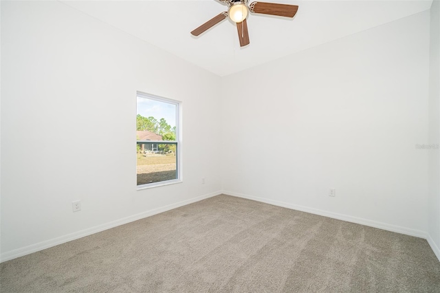 spare room featuring carpet floors and ceiling fan