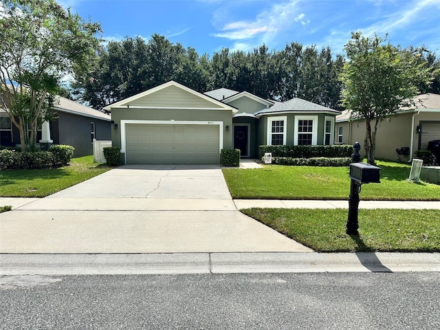 ranch-style house with a garage and a front yard