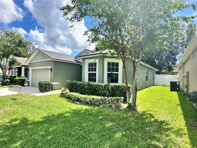 single story home with a garage, central AC, and a front yard