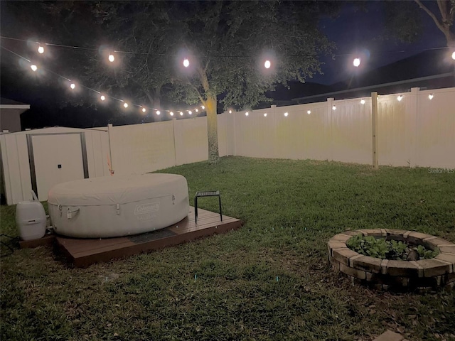 yard at twilight featuring an outdoor fire pit