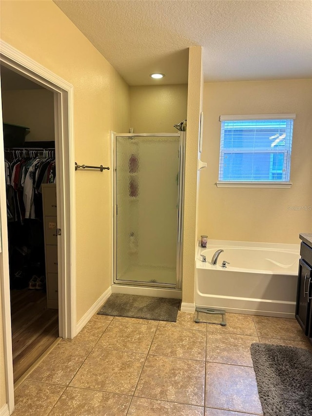 bathroom with vanity, separate shower and tub, and tile patterned floors