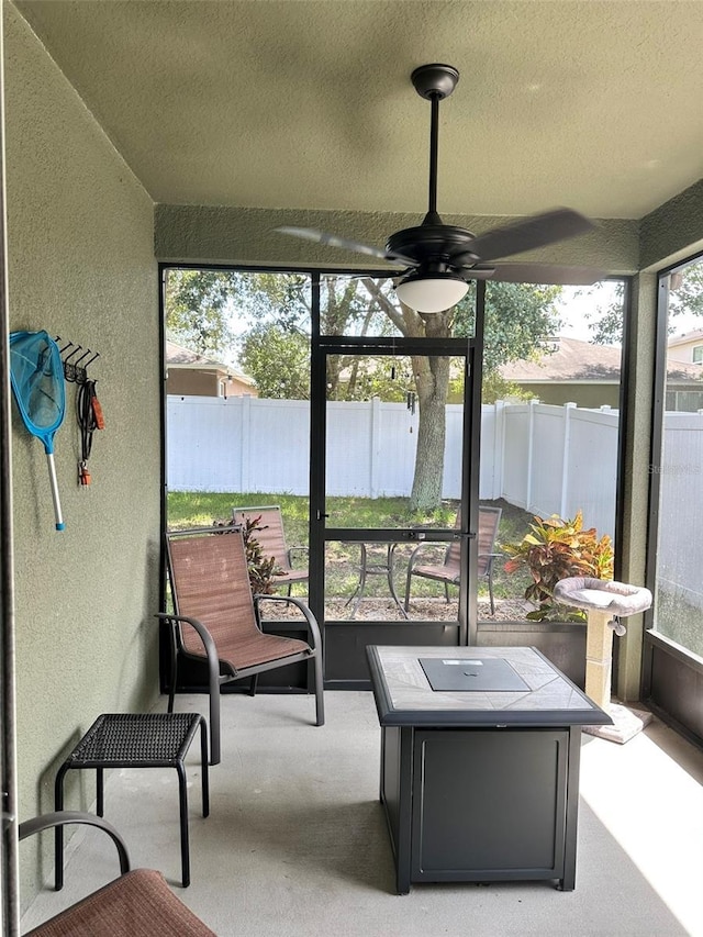 sunroom with ceiling fan and a healthy amount of sunlight