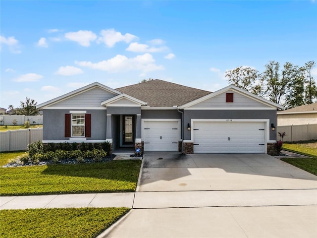 single story home featuring a garage and a front lawn