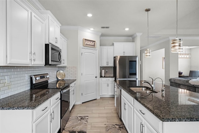 kitchen featuring white cabinetry, stainless steel appliances, and pendant lighting