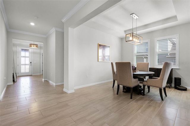 dining area featuring crown molding and a tray ceiling