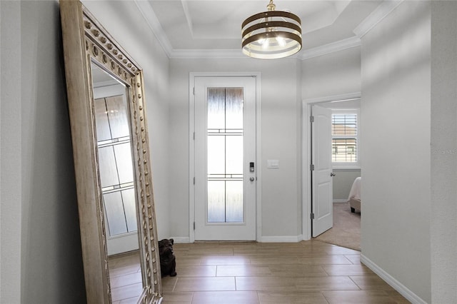 entryway featuring crown molding and a tray ceiling