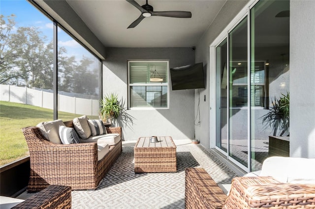 sunroom / solarium featuring ceiling fan and a healthy amount of sunlight