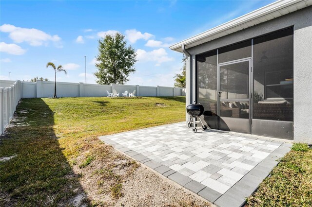 view of yard featuring a sunroom and a patio area