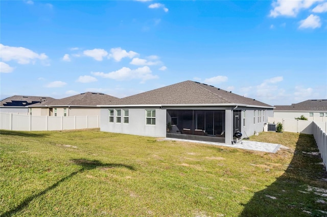 rear view of property with a sunroom, central air condition unit, and a lawn