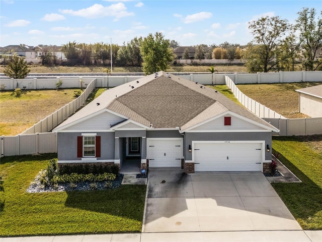 view of front of property featuring a garage and a front lawn