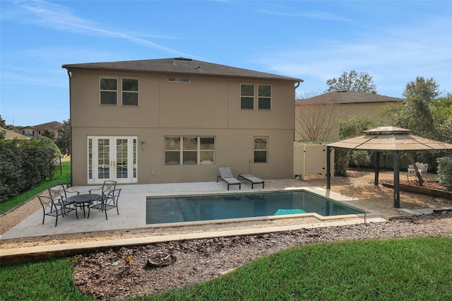 rear view of property featuring french doors and a patio