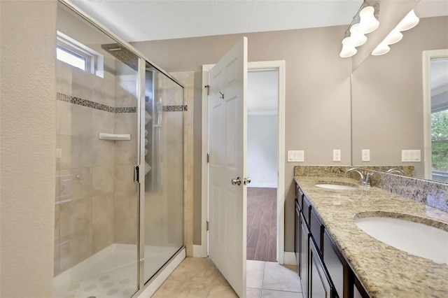 bathroom with vanity, an enclosed shower, and tile patterned flooring