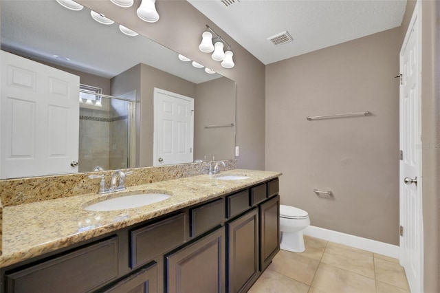 bathroom with vanity, toilet, tile patterned flooring, and a shower with door