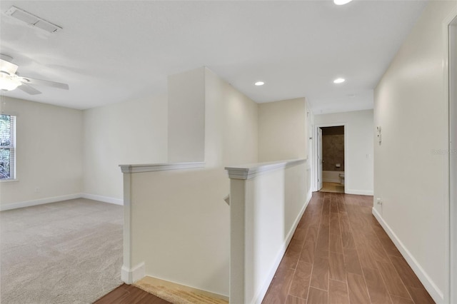 hallway with hardwood / wood-style flooring