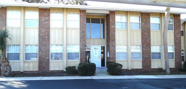 view of building exterior with community garages