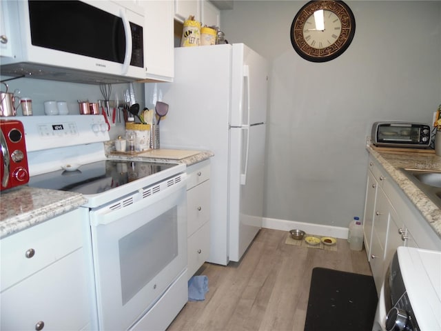 kitchen featuring white cabinetry, white appliances, and light hardwood / wood-style floors