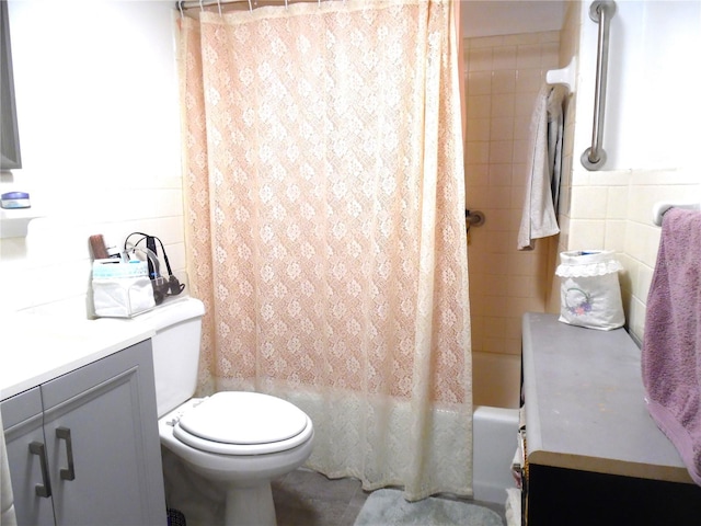 full bathroom featuring shower / bath combination with curtain, vanity, toilet, and tile walls