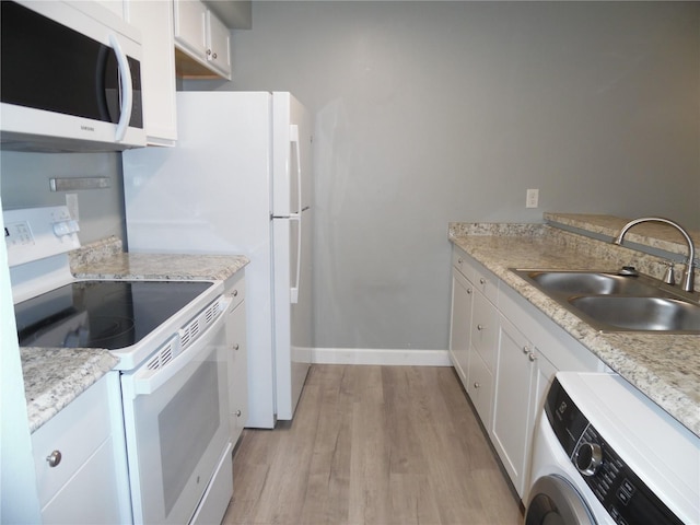 kitchen featuring washer / dryer, a sink, white cabinets, light wood-style floors, and white electric range oven