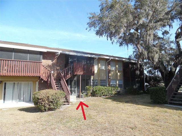 exterior space featuring an attached garage and stairs