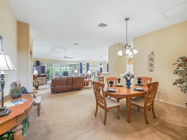 dining area featuring light colored carpet, visible vents, ceiling fan, a textured ceiling, and baseboards