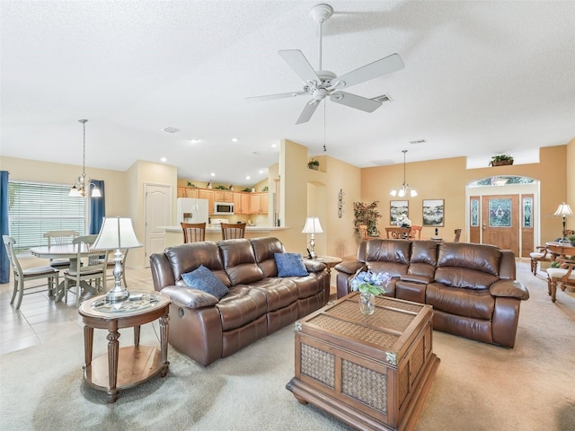 living room with visible vents, vaulted ceiling, a textured ceiling, and ceiling fan with notable chandelier