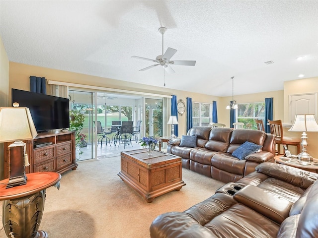 living area with light carpet, ceiling fan, vaulted ceiling, and a textured ceiling