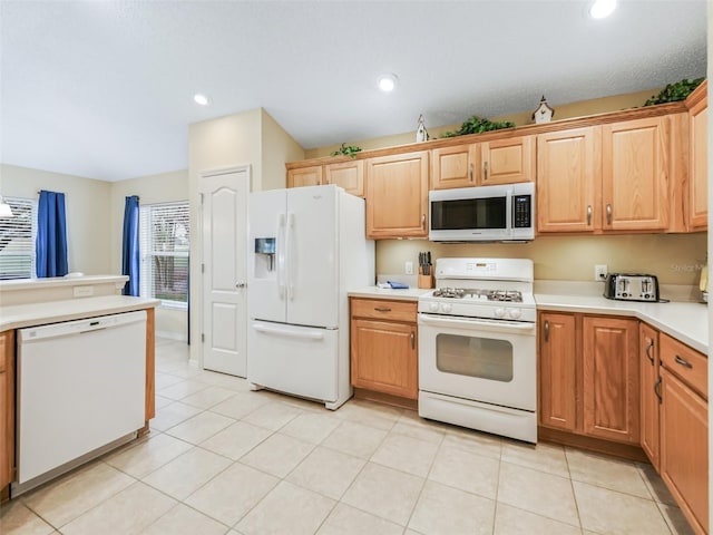 kitchen with light tile patterned floors, light countertops, white appliances, and recessed lighting