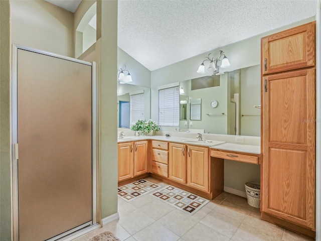 full bath featuring vaulted ceiling, a sink, a shower stall, and a textured ceiling