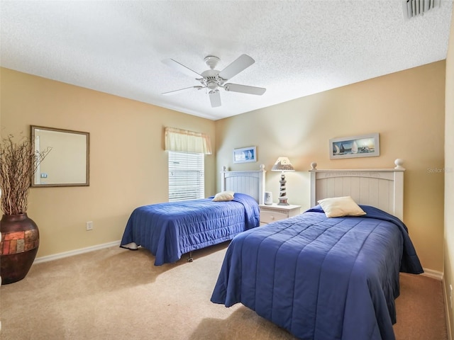 bedroom with light carpet, a textured ceiling, visible vents, and baseboards