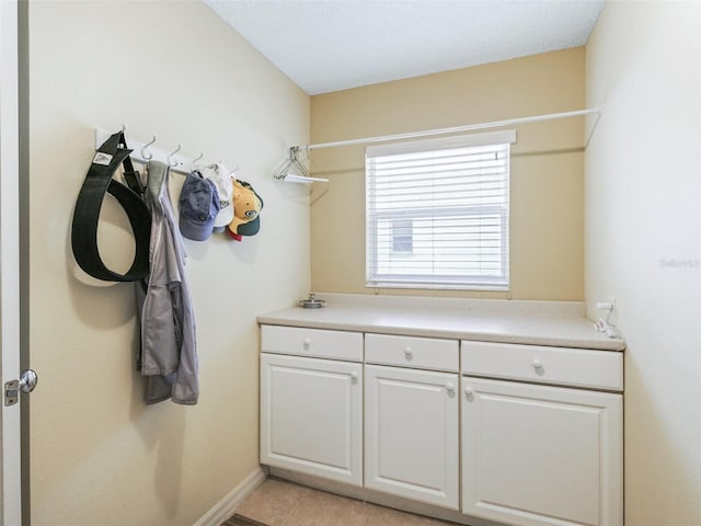 washroom featuring light tile patterned floors and baseboards