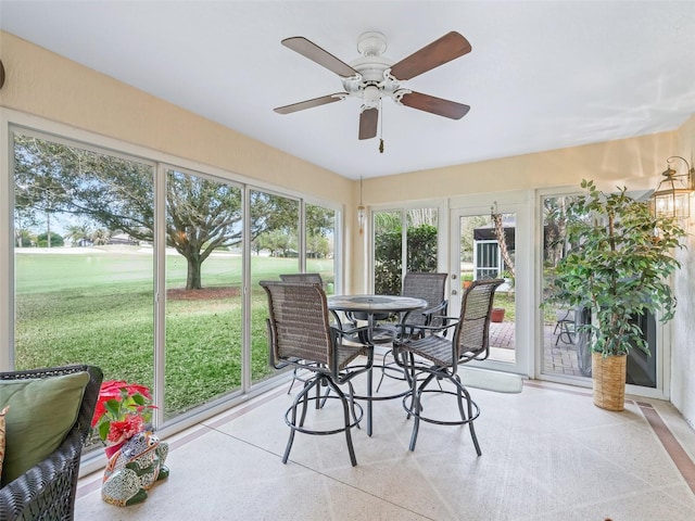 sunroom / solarium with a ceiling fan