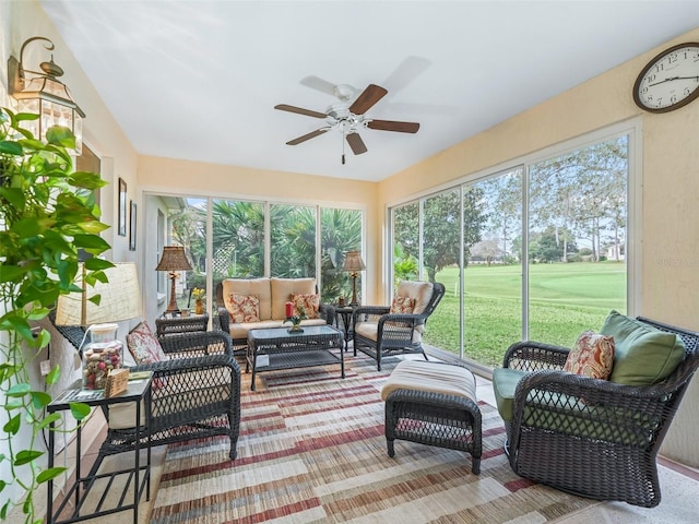 sunroom / solarium featuring a ceiling fan