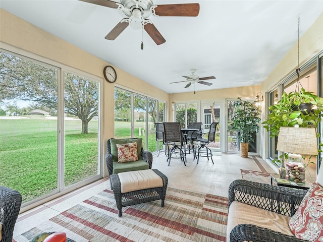 sunroom featuring ceiling fan