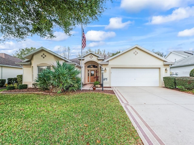 view of front facade featuring a front yard, driveway, an attached garage, and stucco siding