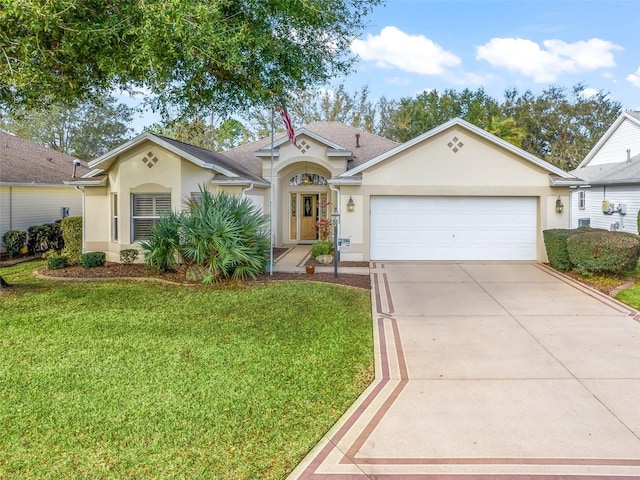 mediterranean / spanish house featuring concrete driveway, a front lawn, an attached garage, and stucco siding