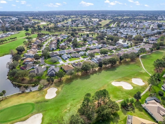 drone / aerial view with a residential view, view of golf course, and a water view