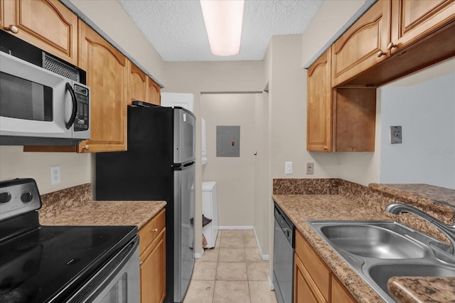 kitchen with sink, light tile patterned floors, electric panel, stainless steel appliances, and a textured ceiling