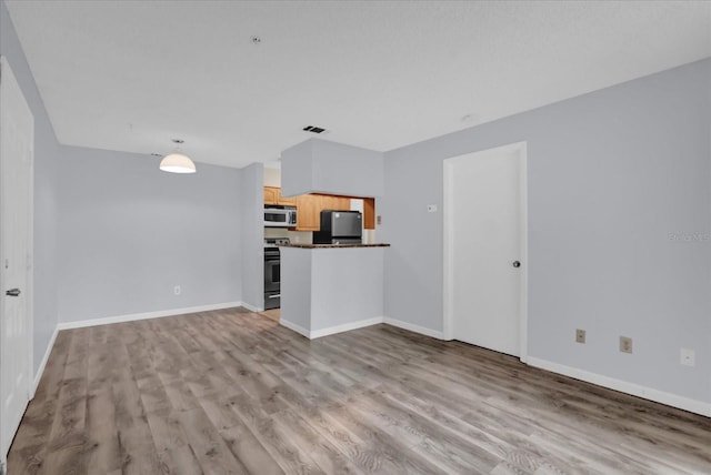 unfurnished living room featuring light wood-type flooring